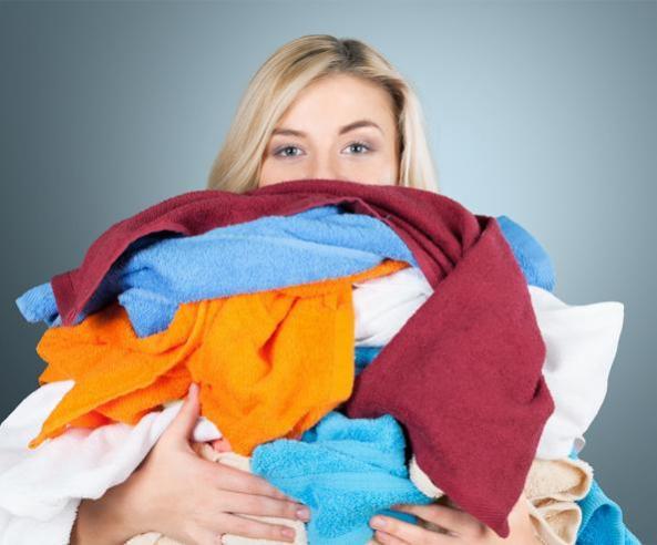 A woman holding bundle of clothes