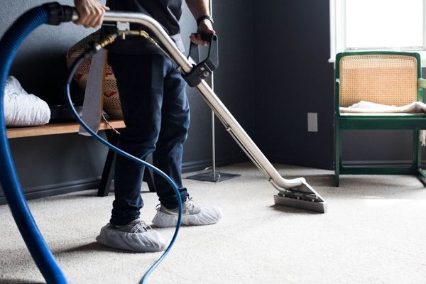 man cleaning carpet