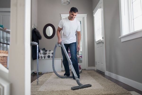 man cleaning carpet