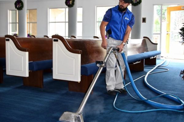 man cleaning carpet