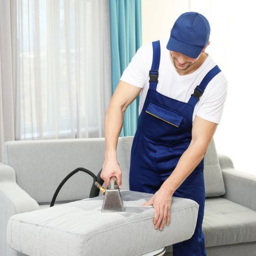 man cleaning sofa