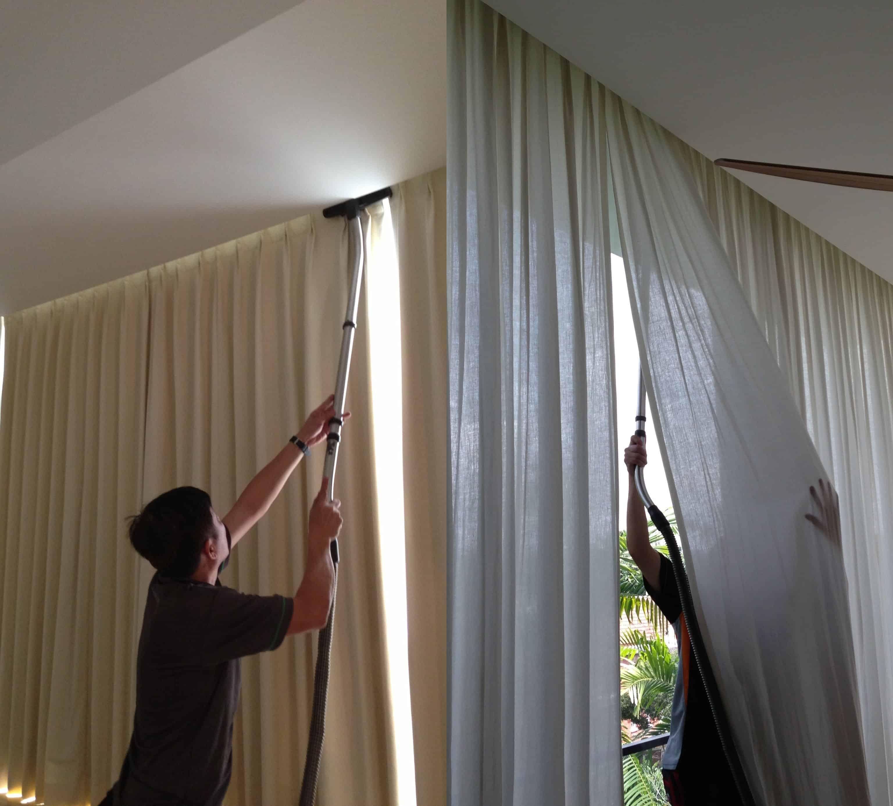 man cleaning curtains