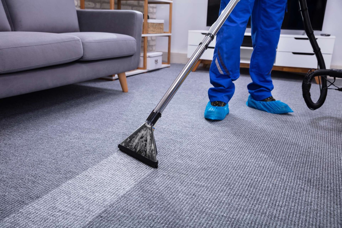 man cleaning carpet