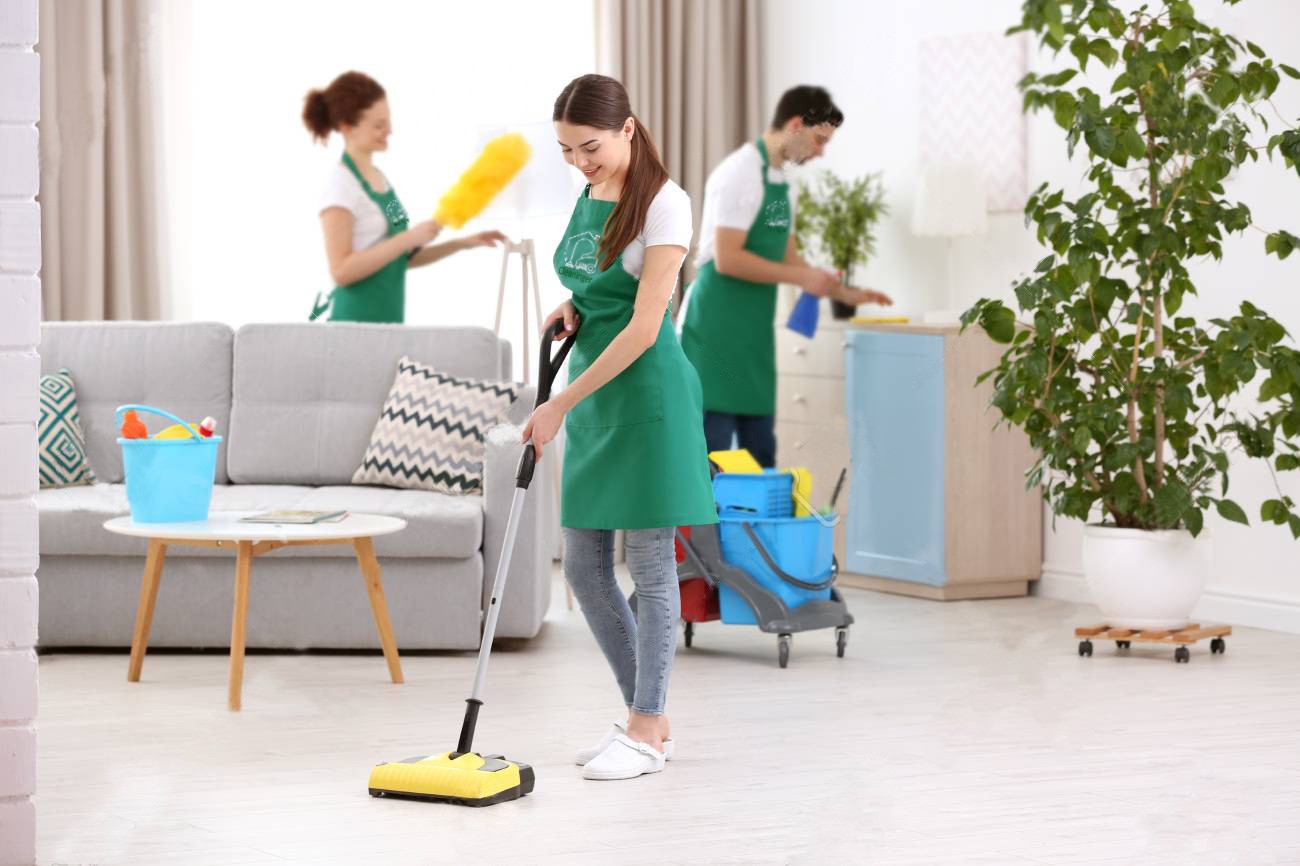 three workers cleaning house