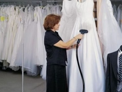 women steaming wedding dress